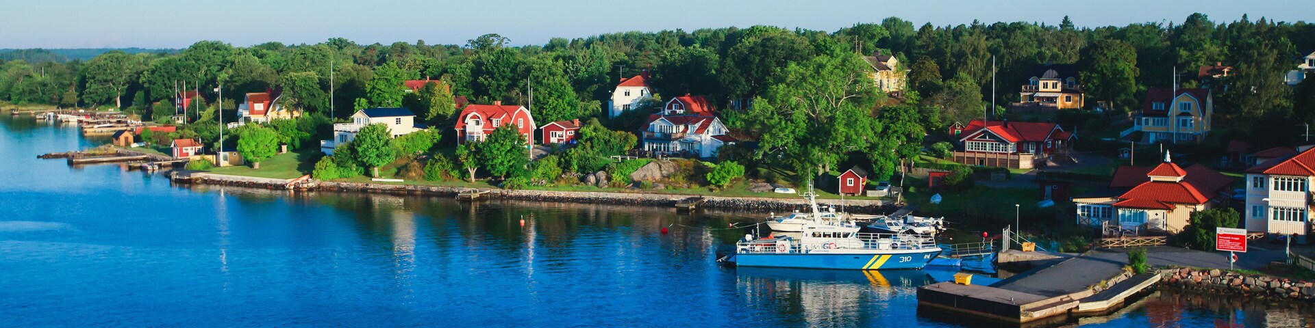 Beautiful super wide-angle panoramic aerial view of Stockholm archipelago, Sweden with harbor and skyline with scenery beyond the city, seen from the ferry, sunny summer day with blue sky