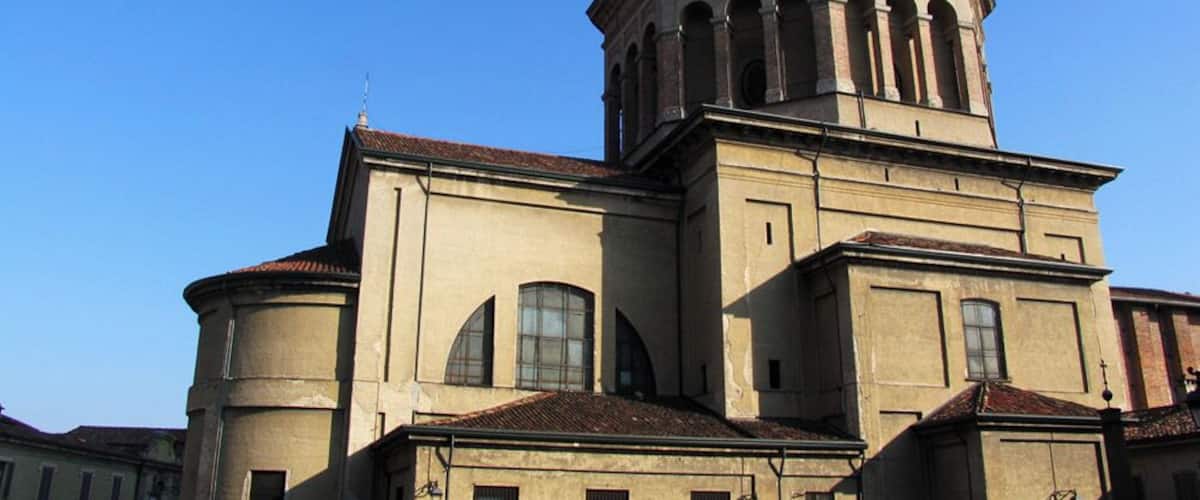 A historic building with a prominent bell tower and arched windows.