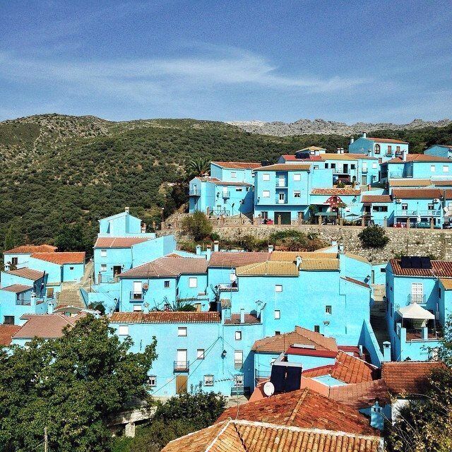 No, you're not seeing things wrong - this whole place is indeed bright blue! 

It's a tiny village in the south of Spain. It used to be one of the traditional 'pueblos blancos ' - the white villages. 

So why is it blue? 

A clever marketing person for the Smurfs movie thought up the new color scheme to promote the flick. A few years later, Júzcar has still kept the place bright blue, and there are references to the Smurfs everywhere.  

It's just as weird in person as it looks on screen, and although there's not too much to see here, if you're a fan of quirky destinations, it's a fun little stop. (#colorful)