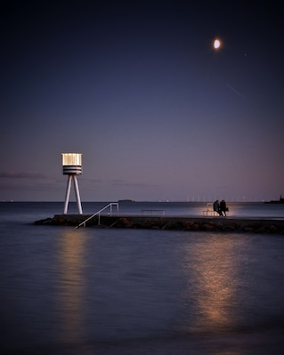 This nice beach is fantastic even in the moonlight. The old lifeguard tower, designed by the famous danish architect Arne Jacobsen, now shines beautiful almost like a lighthouse. Notice the lovers on the bench in the moonlight, sharing a perfect evening by the sea.
#culture #moonlight #beach #coastline