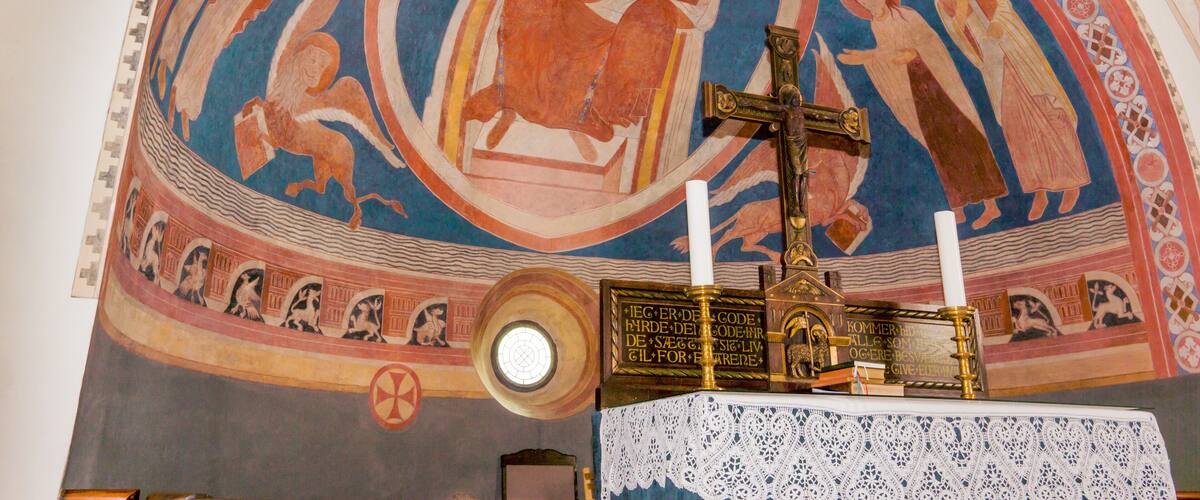 A mosaic with religious figures and a cross.