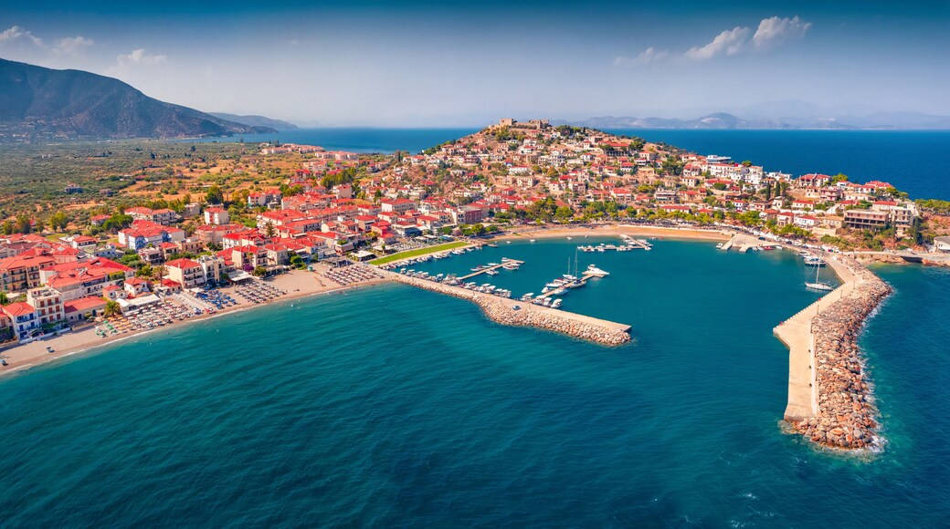 Panonoramic view from flying drone of Astros port. Sunny summer seascape of Myrtoan Sea. Aerial urban scene of Arcadia region, Greece, Europe. Traveling concept background.
