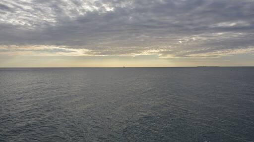 Perfect balance between the ocean and the clouds during a beautiful sunset at the beach. Do you see the sailboat? Hotel Mbweni Ruins near Stone Town, Zanzibar.