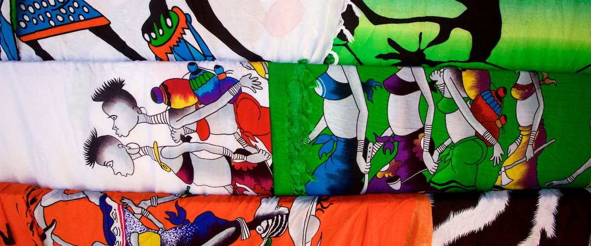 A variety of colorful fabric patterns with abstract and cartoonish designs.