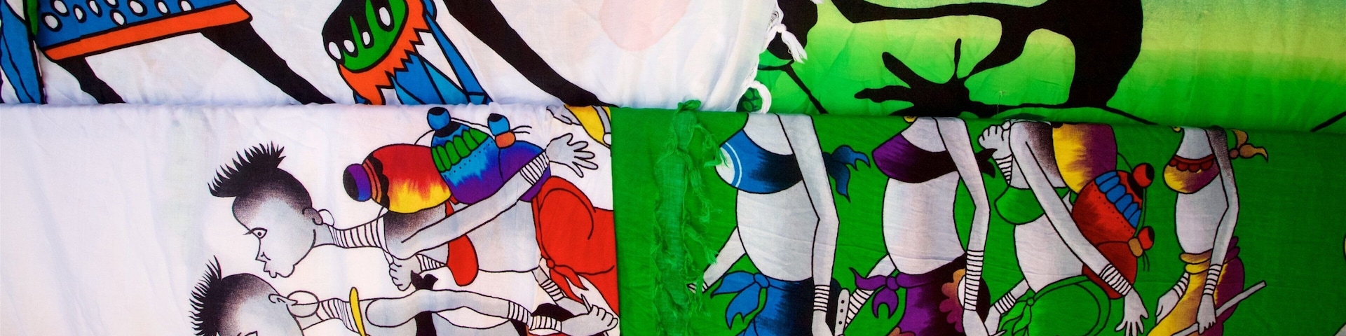 A variety of colorful fabric patterns with abstract and cartoonish designs.