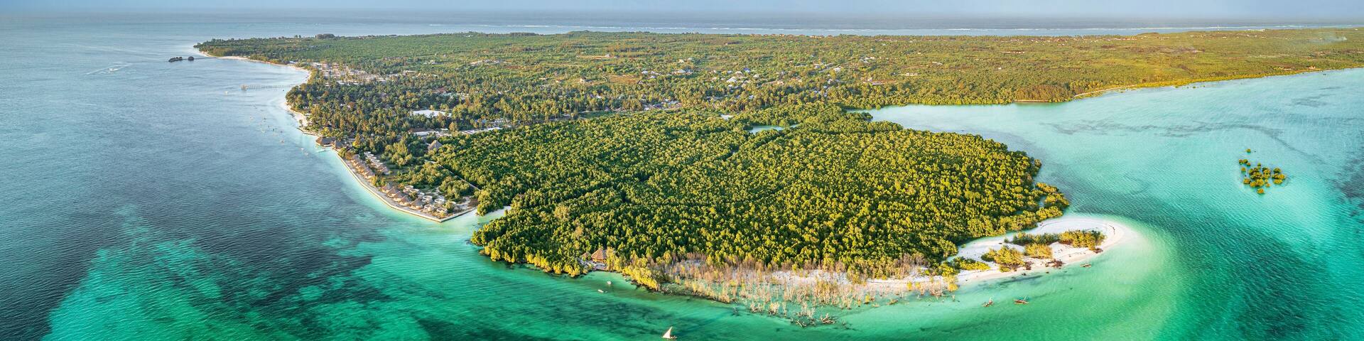 Sunset over lush mangrove forest washed by emerald green water of pristine lagoon, Pingwe, Chwaka Bay, Zanzibar, Tanzania