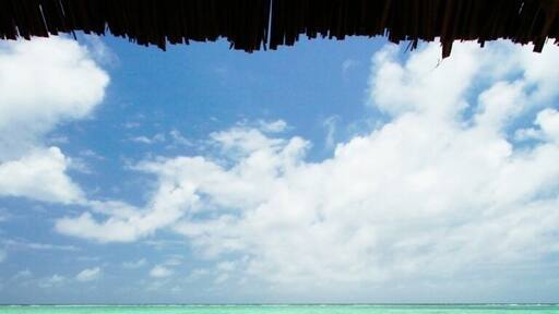 Cabana view of Bwejuu Beach on the east coast of Zanzibar. This luxury resort is a wonderful place to relax after a couple weeks of safari. Either that, or host a small destination wedding here - the white sand beach has been rated one of the best in the world and, due to it's remote location, is never crowded. In fact, The Palms only has six large bungalows while the neighboring property, Breezes, has 60 rooms. Otherwise, the beach is yours to share with the few locals who wander by.