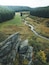 A river winding through a forested valley with rocky outcrops.
