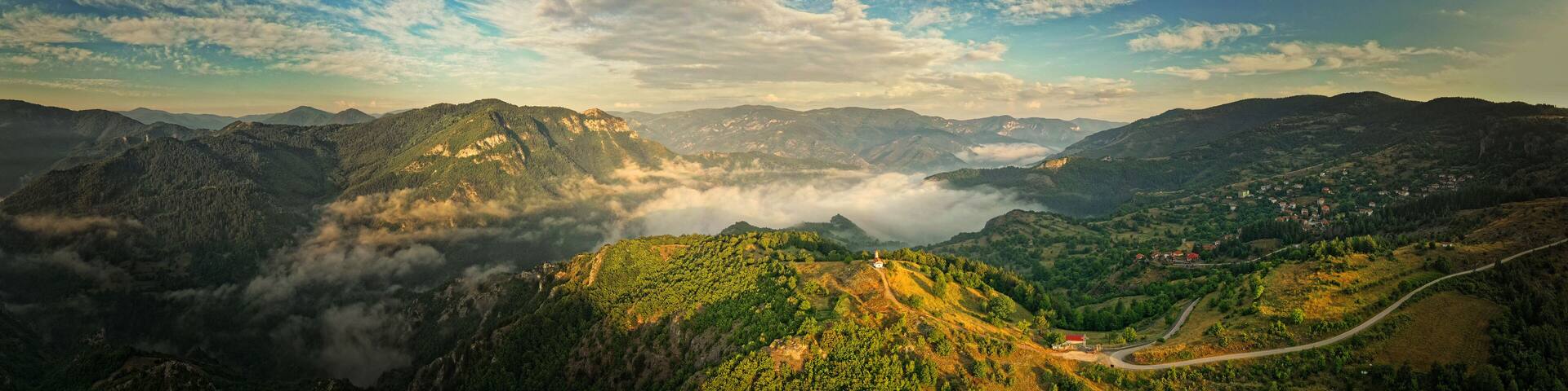 Landscape from Rhodope mountains in Bulgaria during sunset or sunrise. Small chapel and monastery near Borovo, Rhodopes.