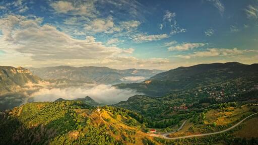 Landscape from Rhodope mountains in Bulgaria during sunset or sunrise. Small chapel and monastery near Borovo, Rhodopes.