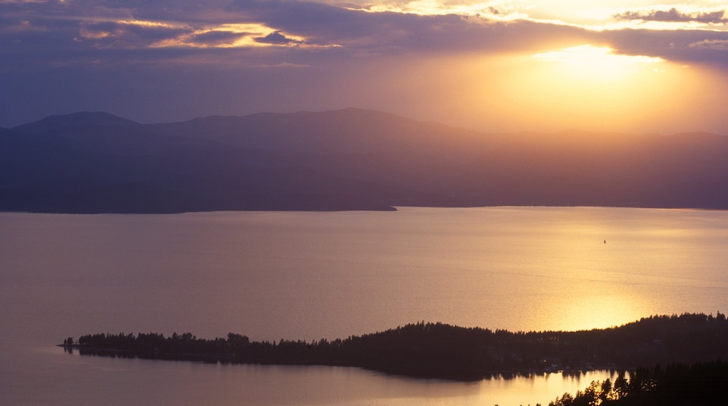 Flathead Lake which includes a lake or waterhole and a sunset