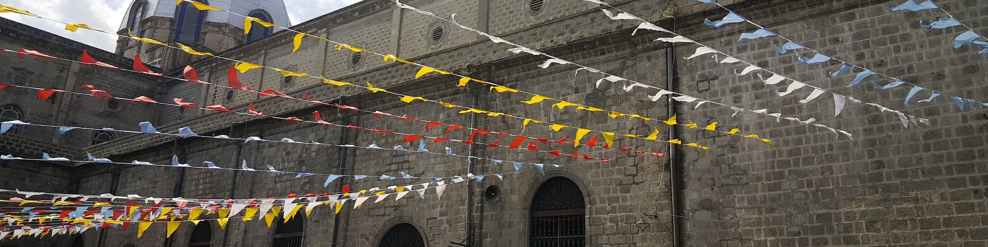Colorfull flags at Santo Rosario church in Angeles, Philippines