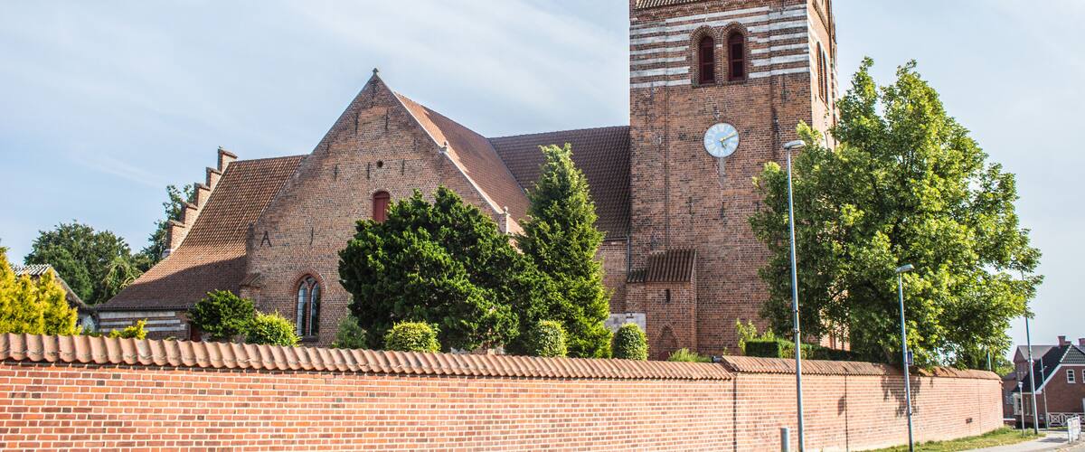 A historic church with a tall tower and a clock.
