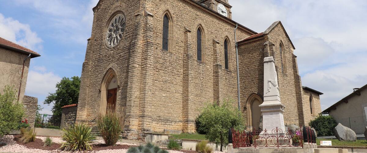 A historic stone church with a tall steeple, arched windows, and a large rose window.