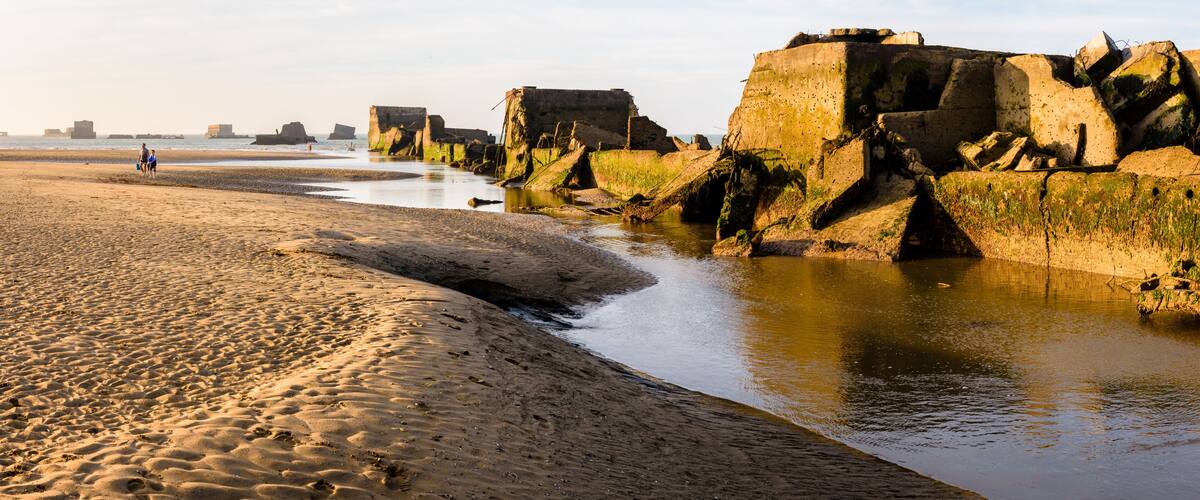 Remains of Phoenix caissons lying on the sand at low tide in Asnelles, France, used to build the artificial Mulberry harbour on Gold Beach after the Normandy landings in WWII.