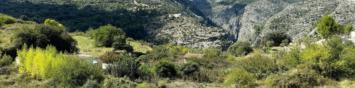 Panoramic view of the Hell's Ravine, or El Barranc de l'Infern, in La Vall de Laguar. One of the hardest hiking routes in Spain. The Cavall Verd mountain and the town Benimaurell are in the background