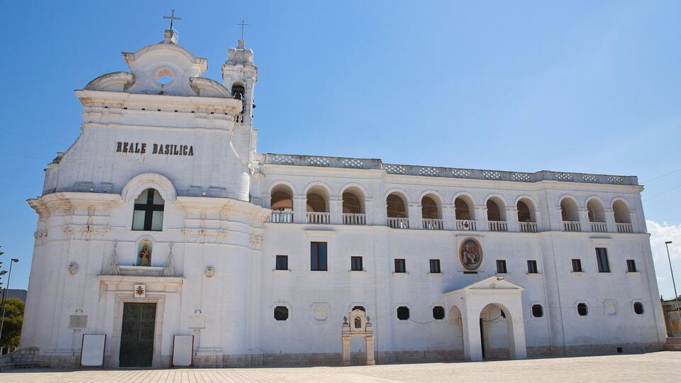 A large white church with arched windows and a bell tower.