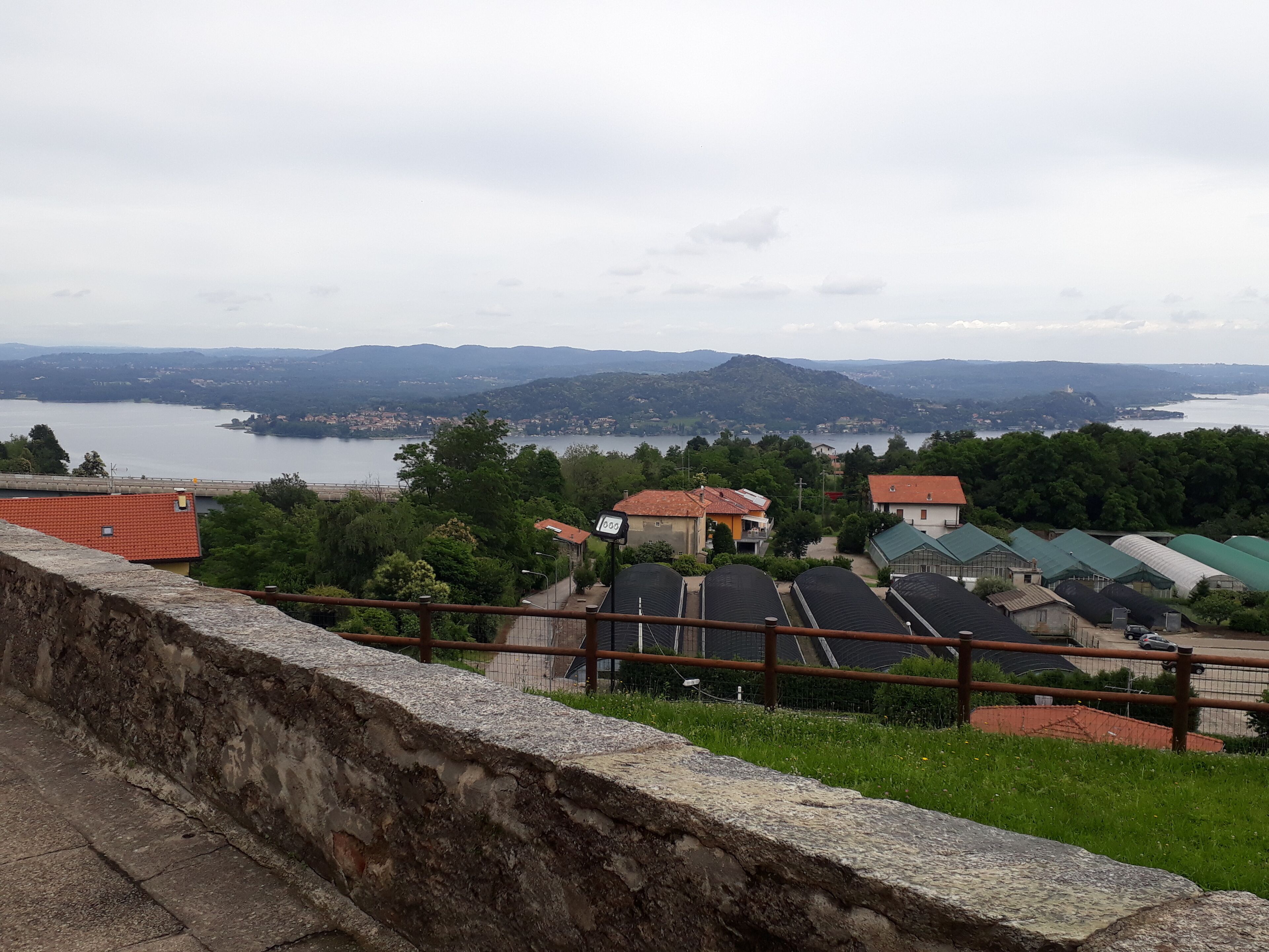 A scenic view of a lake with surrounding houses and greenery.