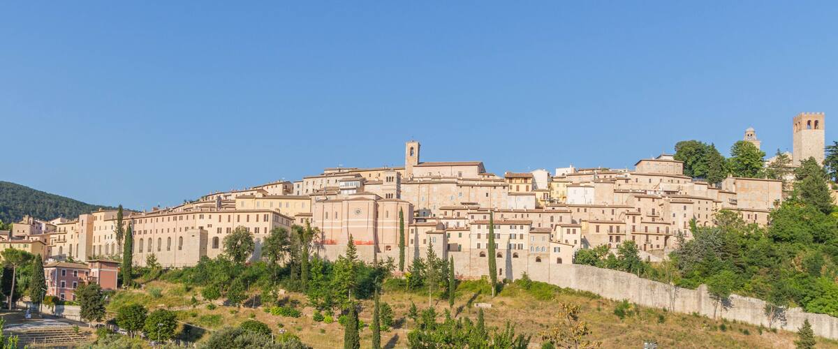 A historic town with medieval architecture, including towers and a fortified wall.