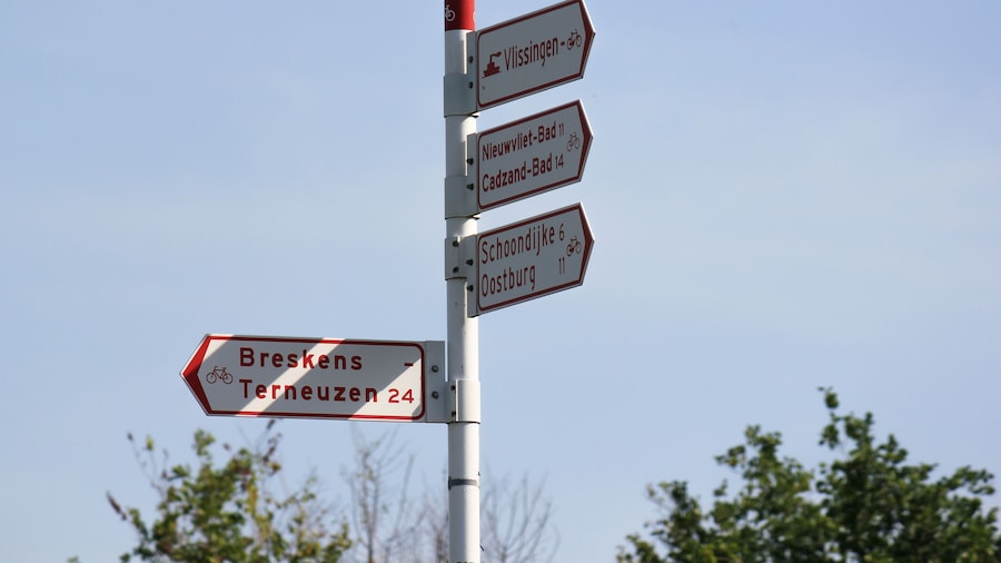 Dutch bicycle signpost in Breskens with shadow from the sun