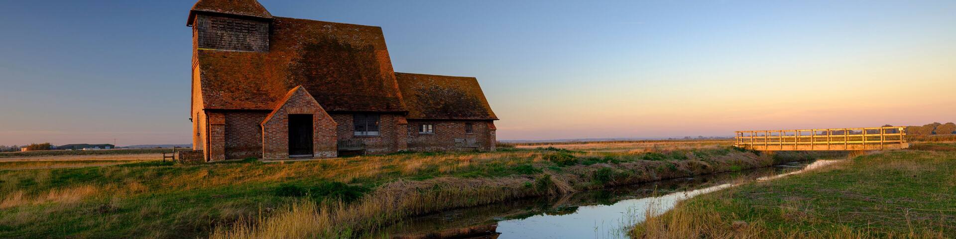 Autumnal clear evening sunset over St Thomas a Becket Church, Fairfield, in the Romney Marsh, Kent, UK