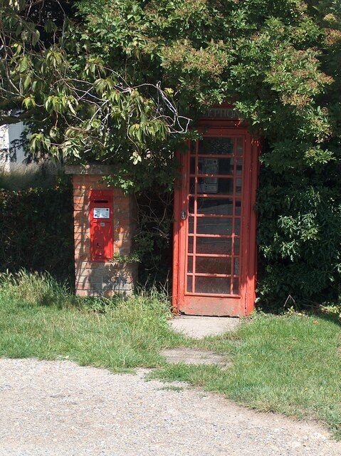 Public phone box at Ivychurch With mobile phones so widespread, how long will it be before these traditional red phone boxes disappear from our landscape?