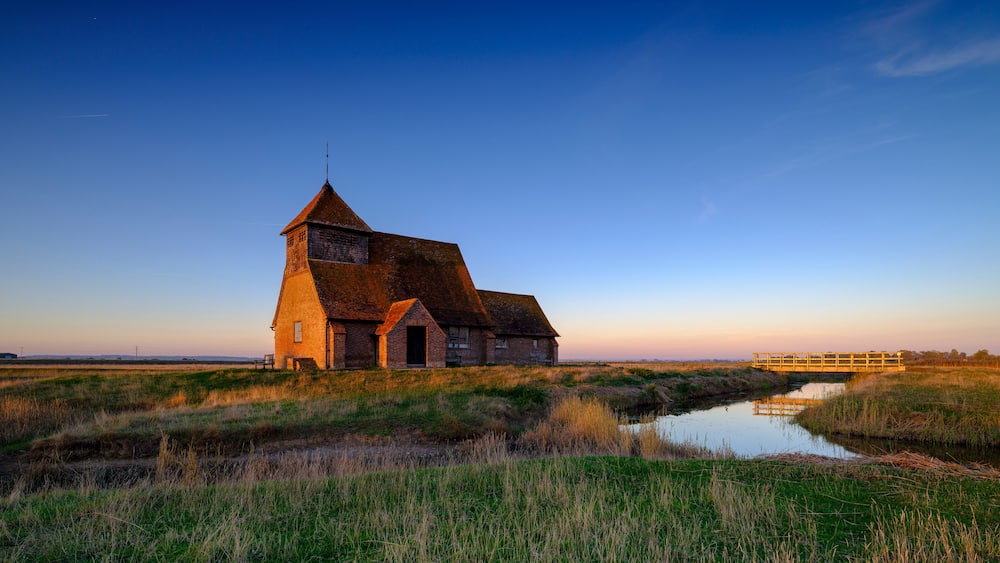 Autumnal clear evening sunset over St Thomas a Becket Church, Fairfield, in the Romney Marsh, Kent, UK