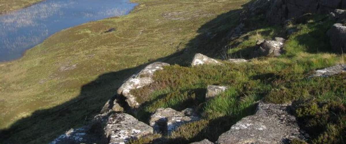 Loch Caorach From the lower slopes of Beinn nan Ord. Ardnamurchan Lighthouse can be seen.