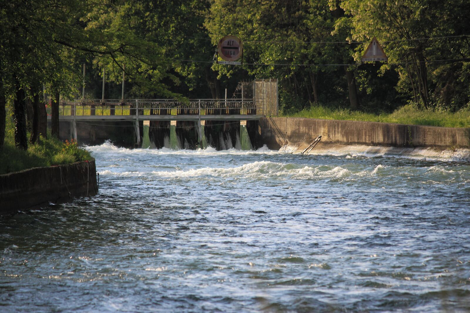 A river with a bridge and a dam.
