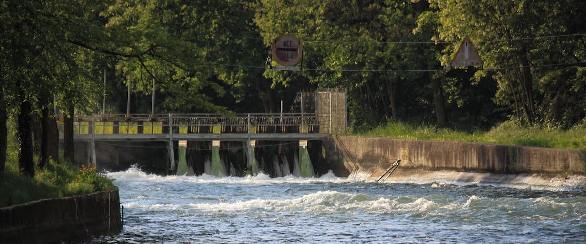 A river with a bridge and a dam.