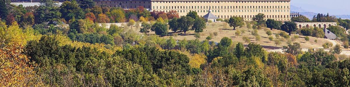 El Escorial was built by King Philip II in the late 16th century to serve as both a royal palace and as the seat of the Catholic Church in Spain. In addition to the palace the complex includes a basilica, a convent, a school, a library, and a pantheon.
While El Escorial is impressive from the outside, we actually found it a little austere on the inside. In many ways it felt more like a fine art museum than a typically elaborate European palace (such as Versailles). That said, there are some impressive sights, including works by El Greco, Bernini, and Giardini. The library was also quite beautiful, with richly carved wood shelves, a marble floor, and a colorful fresco ceiling by Pellegrino Tibaldi.
For me, the highlight of the tour was the 180ft long (55m) Hall of Battles – a barrel-vaulted room where the walls were completely covered in frescos depicting Spain's military victories over the Moors and the French. All aspects of the battle field were portrayed (when you have 180ft, that is quite doable), and the artist employed an interesting trick whereby the more distant, smaller scenes were less saturated, and the background mountains and landscape were set in hues of blue.
Overall I'd say El Escorial is worth a visit, but you probably won't need more than a couple of hours to enjoy it.