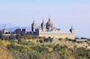 El Escorial was built by King Philip II in the late 16th century to serve as both a royal palace and as the seat of the Catholic Church in Spain. In addition to the palace the complex includes a basilica, a convent, a school, a library, and a pantheon.
While El Escorial is impressive from the outside, we actually found it a little austere on the inside. In many ways it felt more like a fine art museum than a typically elaborate European palace (such as Versailles). That said, there are some impressive sights, including works by El Greco, Bernini, and Giardini. The library was also quite beautiful, with richly carved wood shelves, a marble floor, and a colorful fresco ceiling by Pellegrino Tibaldi.
For me, the highlight of the tour was the 180ft long (55m) Hall of Battles – a barrel-vaulted room where the walls were completely covered in frescos depicting Spain's military victories over the Moors and the French. All aspects of the battle field were portrayed (when you have 180ft, that is quite doable), and the artist employed an interesting trick whereby the more distant, smaller scenes were less saturated, and the background mountains and landscape were set in hues of blue.
Overall I'd say El Escorial is worth a visit, but you probably won't need more than a couple of hours to enjoy it.