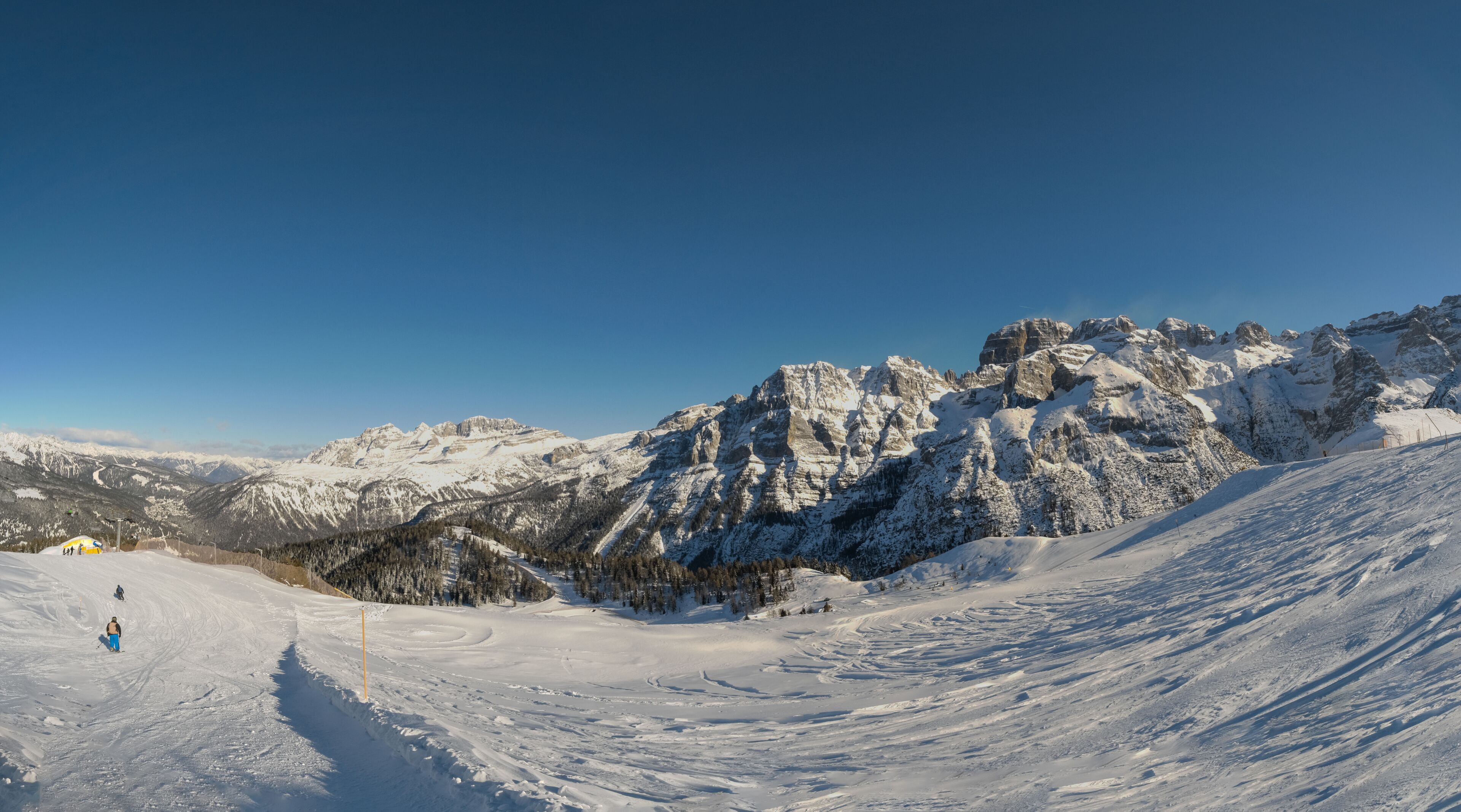A snow-covered mountain range with a clear sky.