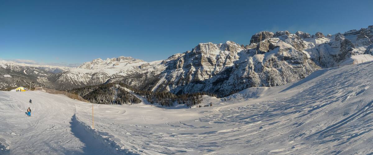 A snow-covered mountain range with a clear sky.
