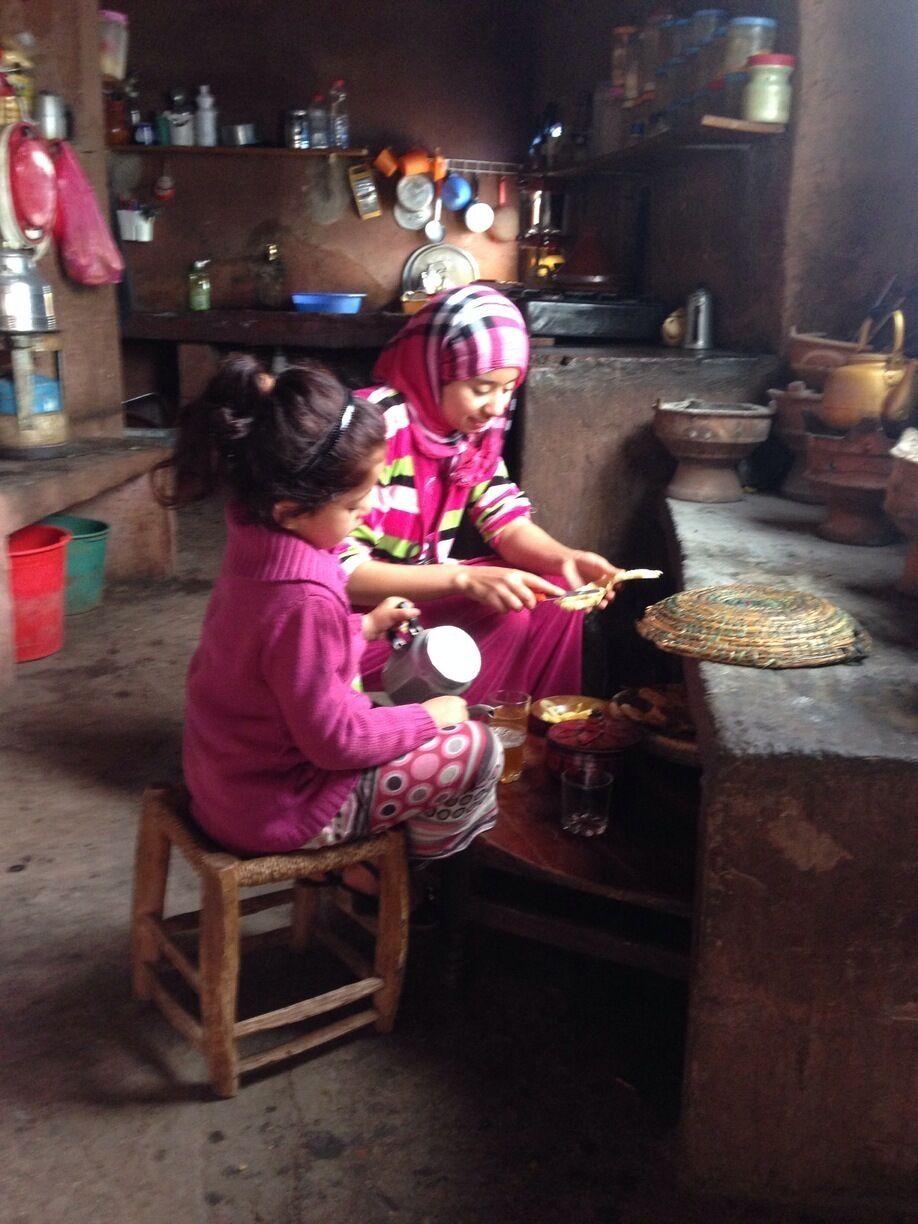 Berber mother and daughter cooking in their kitchen. 