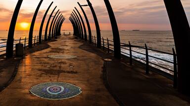 View of the Indian Ocean through the Millenium Pier in Umhlanga Rocks at Sunrise