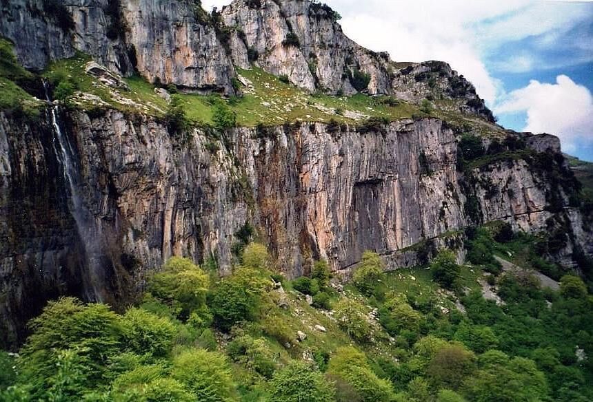 Source of the river Ason in the Natural Park Hillocks of the Ason (Cantabria, Spain). Resurgent stream in a karst region. The water falls by a cascade of more than 50 meters of height.