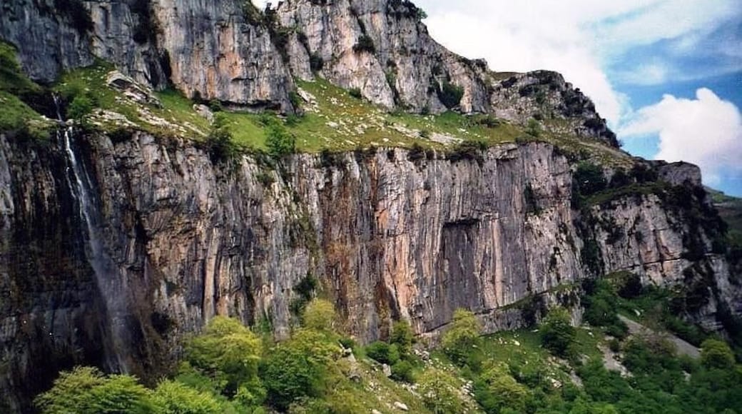 Source of the river Ason in the Natural Park Hillocks of the Ason (Cantabria, Spain). Resurgent stream in a karst region. The water falls by a cascade of more than 50 meters of height.