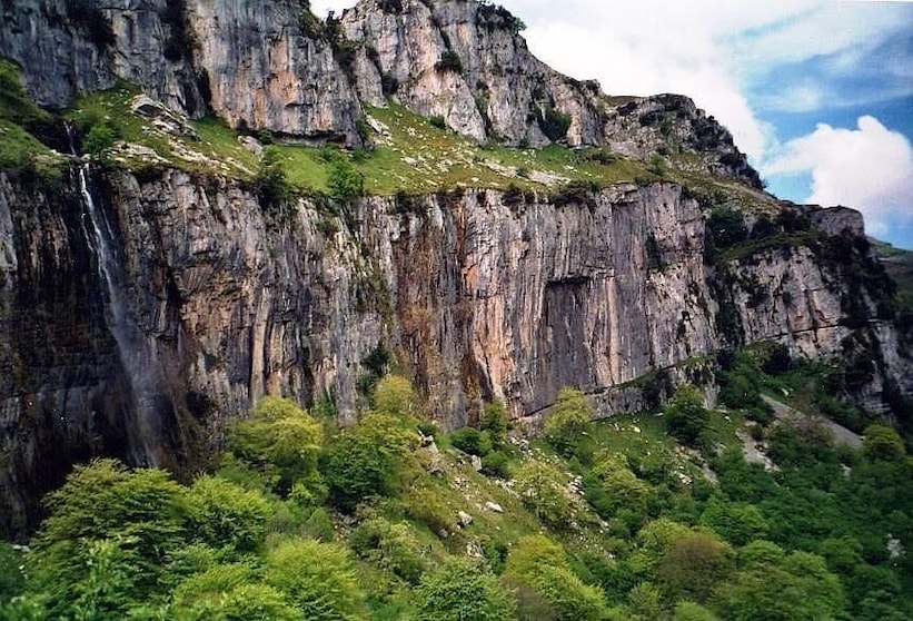 Source of the river Ason in the Natural Park Hillocks of the Ason (Cantabria, Spain). Resurgent stream in a karst region. The water falls by a cascade of more than 50 meters of height.
