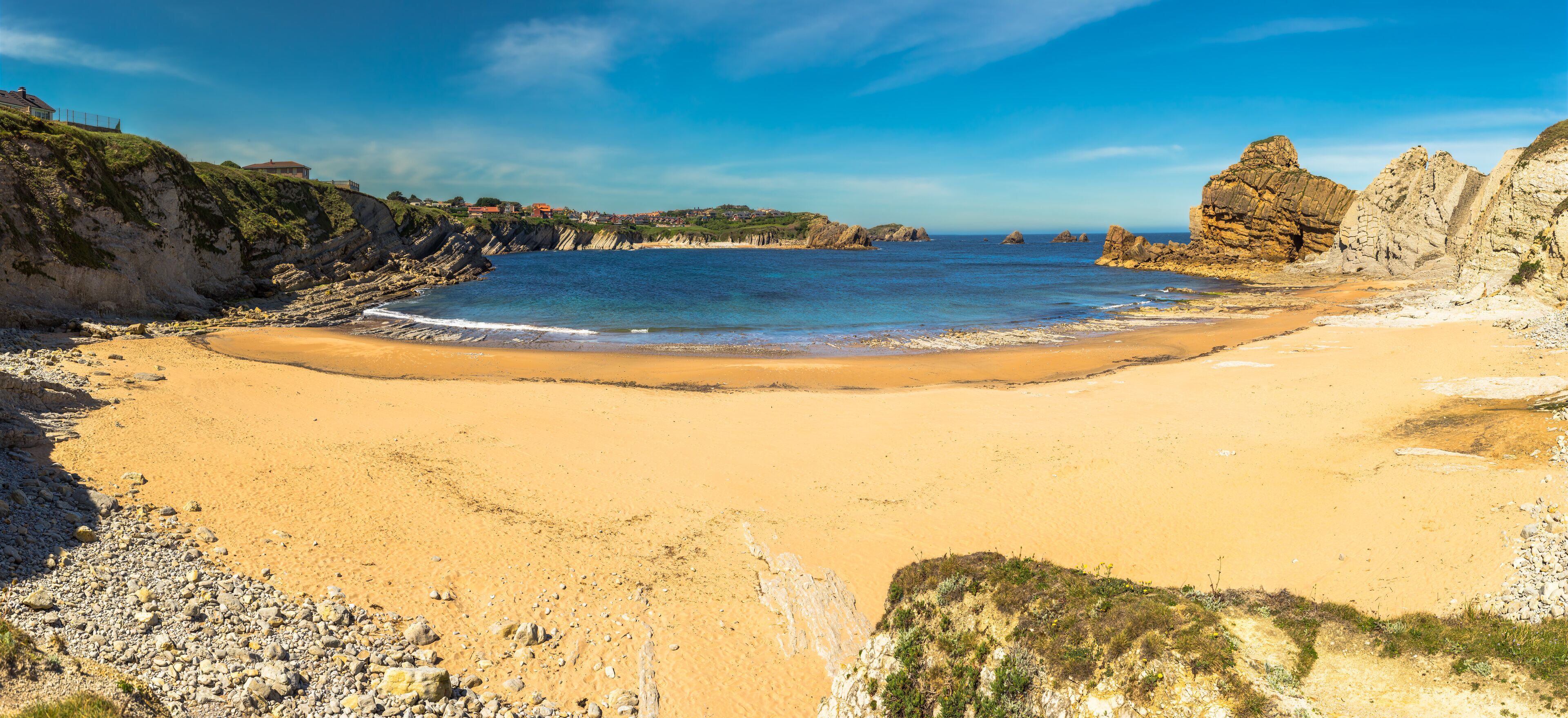 Panoramic view of Portio beach on sunny day, Pielagos, Cantabria, Spain