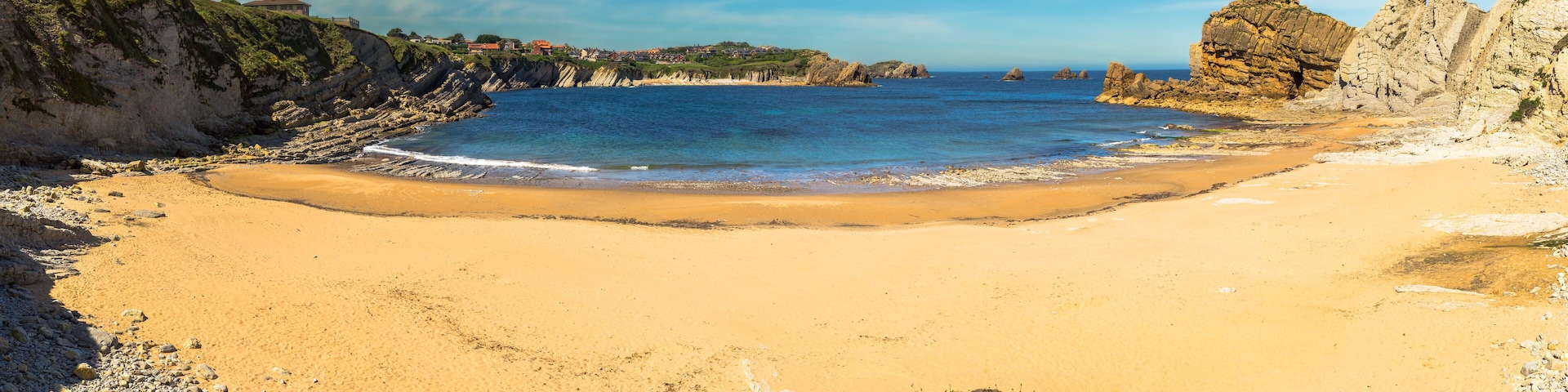 Panoramic view of Portio beach on sunny day, Pielagos, Cantabria, Spain