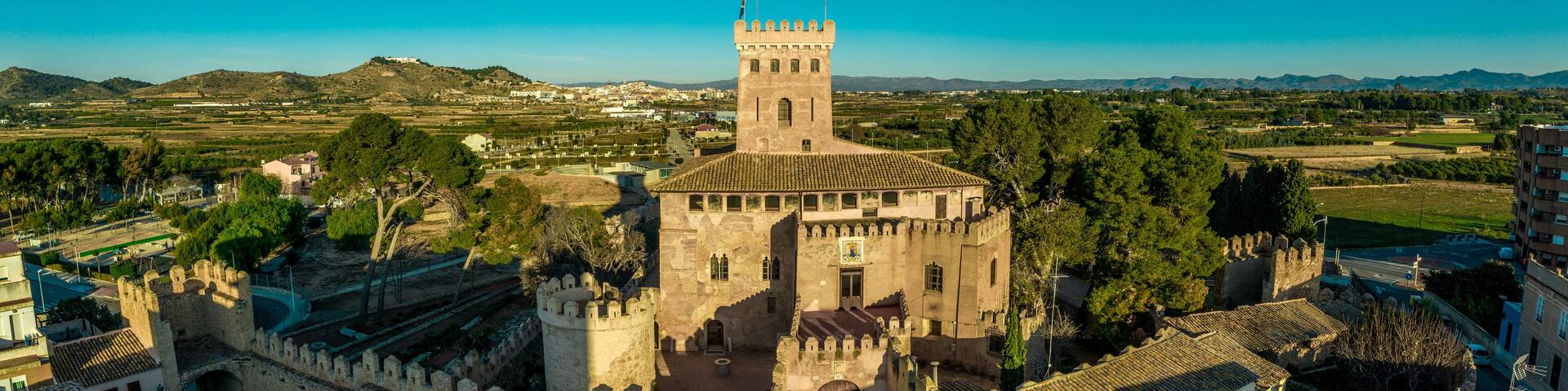 Aerial morning view of the gate and donjon of fully restored Gothic castle in Benisano Valencia province Spain