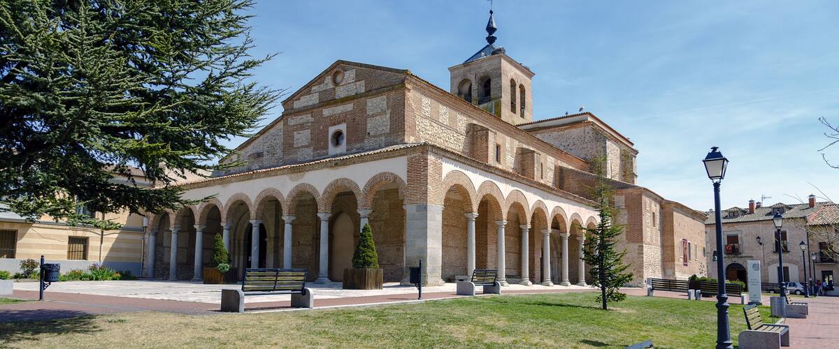 A historic building with a bell tower and arched colonnade.
