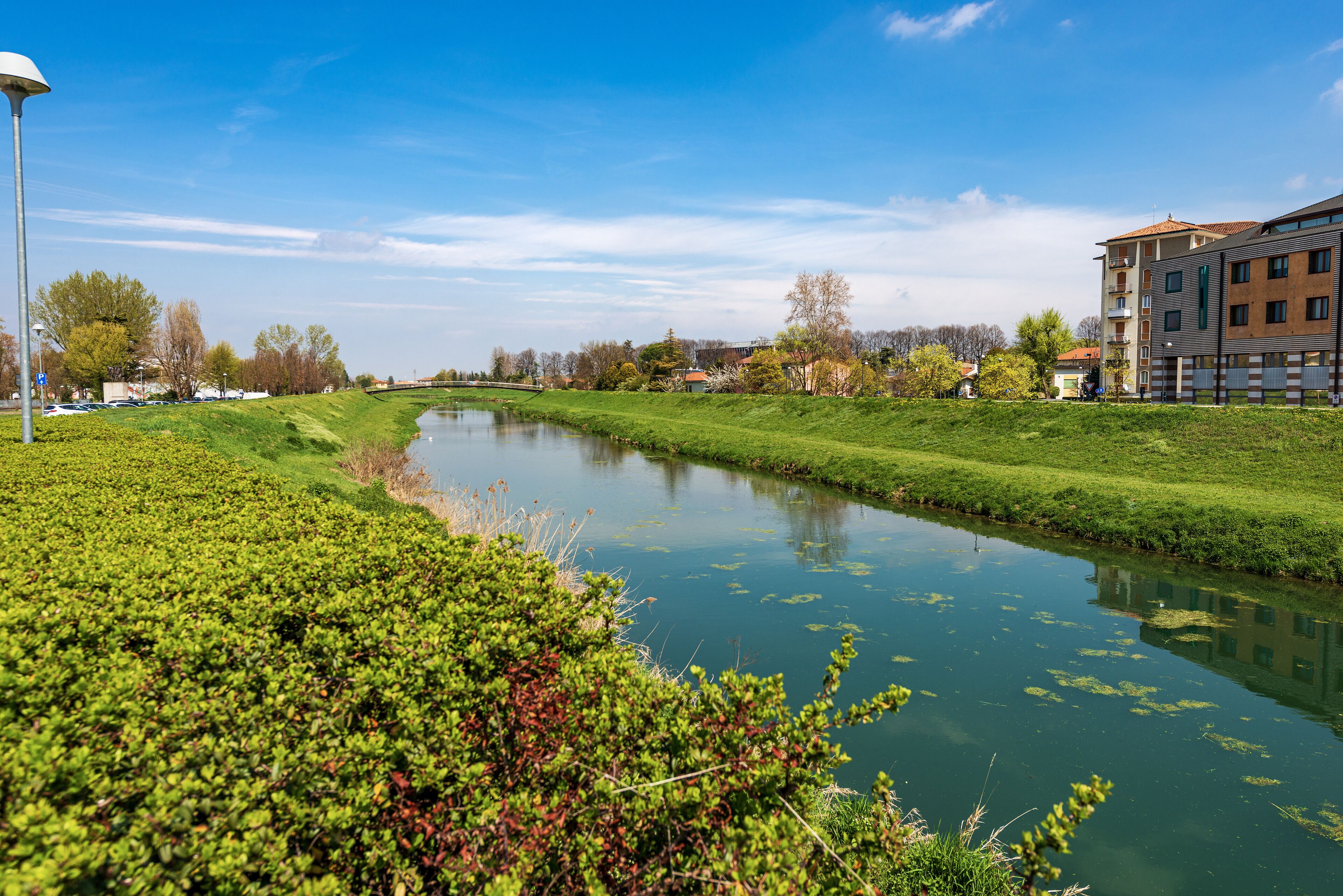 The River Monticano with the green banks in springtime, small town of Oderzo, Treviso province, Veneto, Italy, Europe.