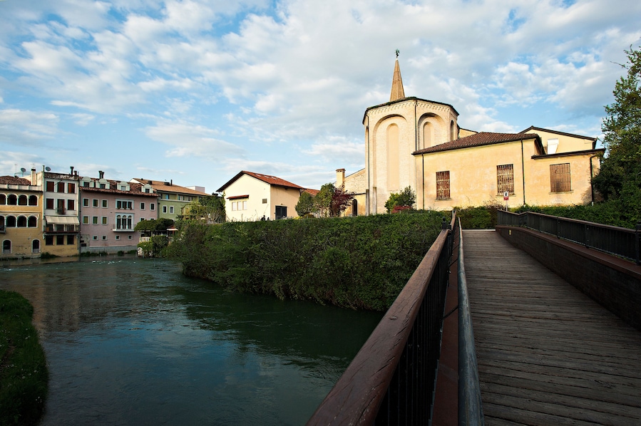 The bell tower and the cathedral of San Niccolò in Sacile on the river livenza.
Pordenone district, Italy.