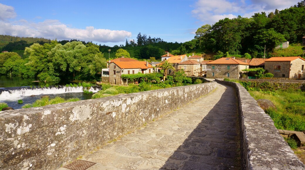 The Camino of Santiago on its passage through the roman bridge Ponte Vella in Ponte Maceira, Ames, Galicia, Spain