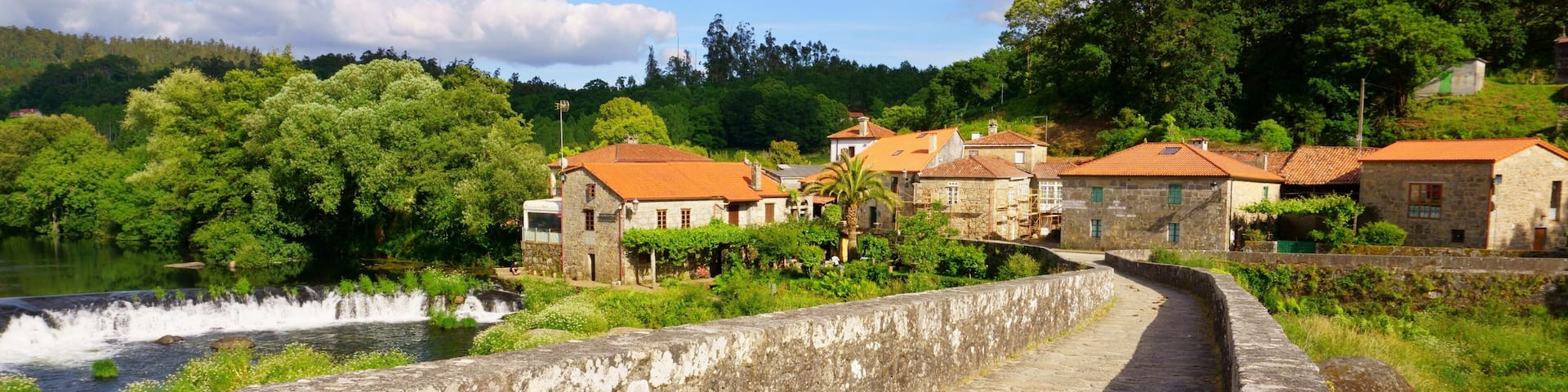 The Camino of Santiago on its passage through the roman bridge Ponte Vella in Ponte Maceira, Ames, Galicia, Spain