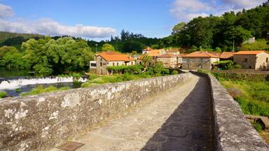 The Camino of Santiago on its passage through the roman bridge Ponte Vella in Ponte Maceira, Ames, Galicia, Spain