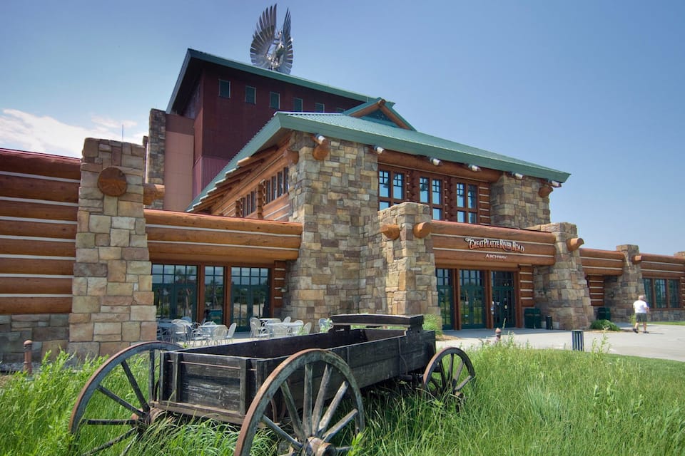 A rustic building with stone walls and a sign reading "Great Platte River Road."