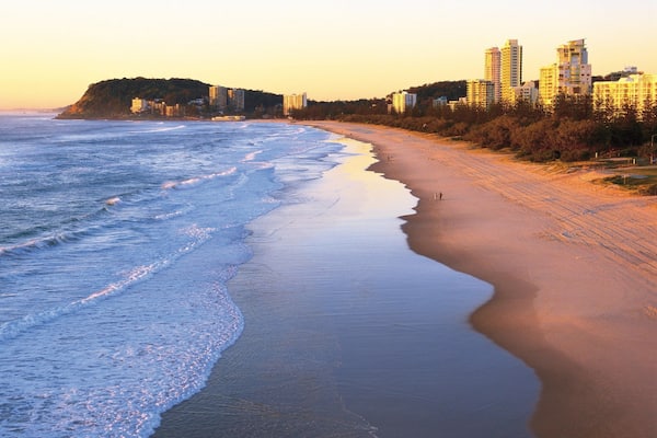 Burleigh Beach which includes tropical scenes, a sunset and a coastal town